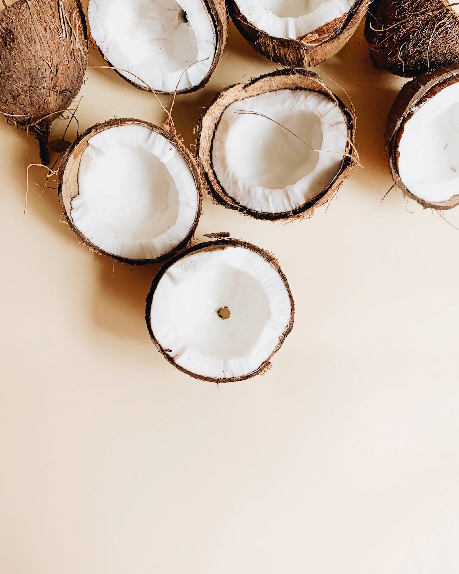 Halved coconuts showing white coconut flesh