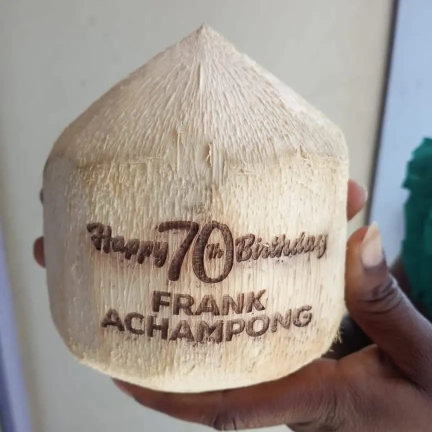 A fresh coconut laser-engraved with a happy 70th birthday message